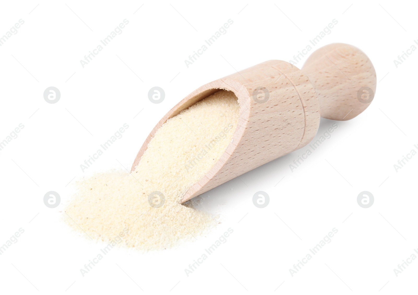 Photo of Wooden scoop with uncooked organic semolina isolated on white