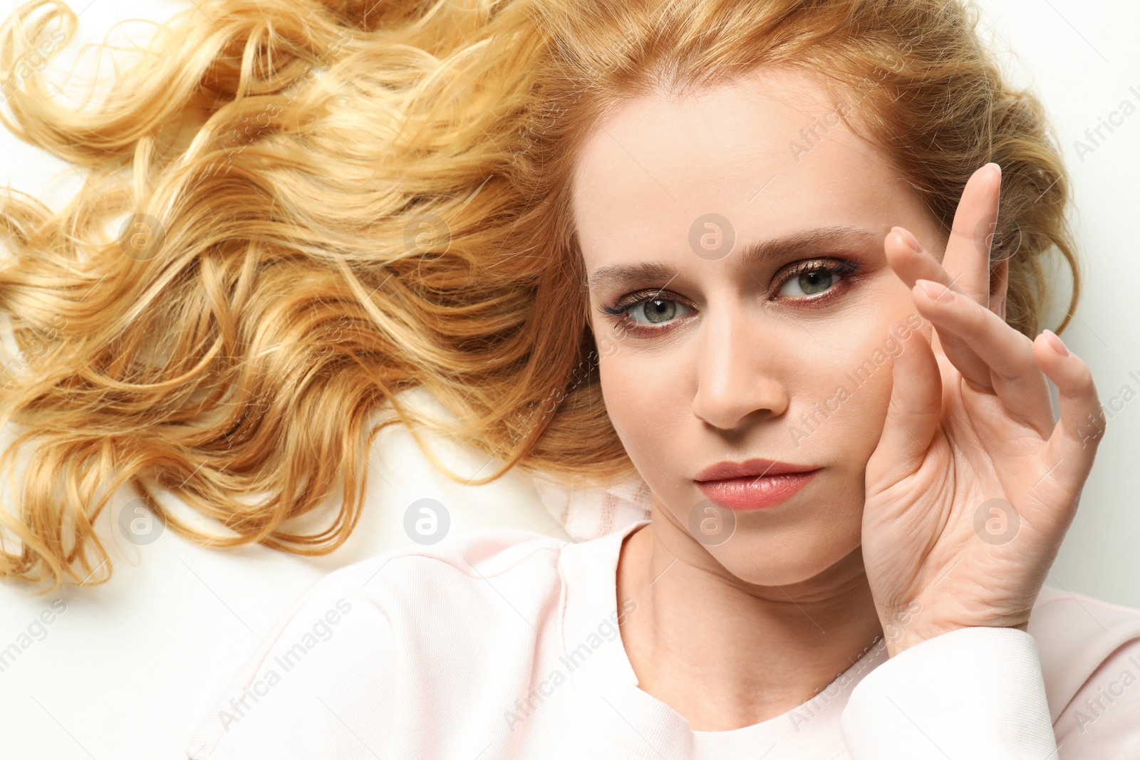 Photo of Portrait of beautiful young woman with dyed long hair on white background, top view