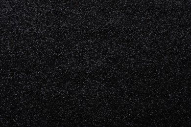 Photo of Beautiful shiny black glitter as background, closeup