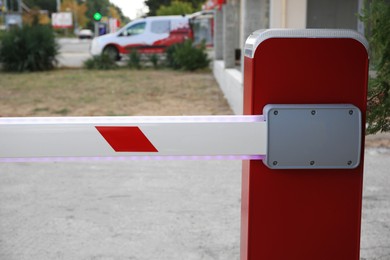 Photo of Closeup view of closed automatic boom barrier outdoors