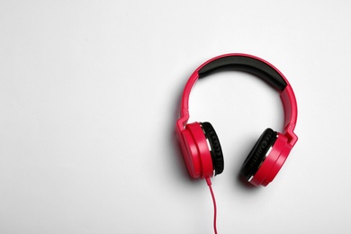 Photo of Stylish modern headphones on white background, top view