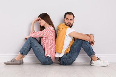 Unhappy young couple with relationship problems indoors