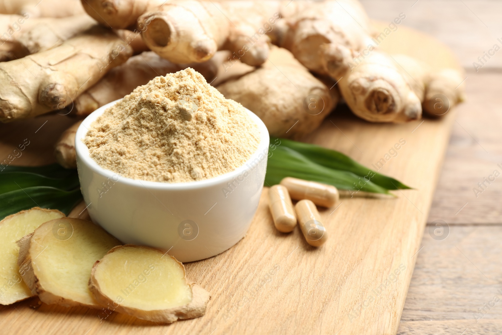 Photo of Dry, fresh and capsuled ginger on wooden table. Space for text