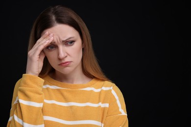 Photo of Portrait of sad woman on black background, space for text