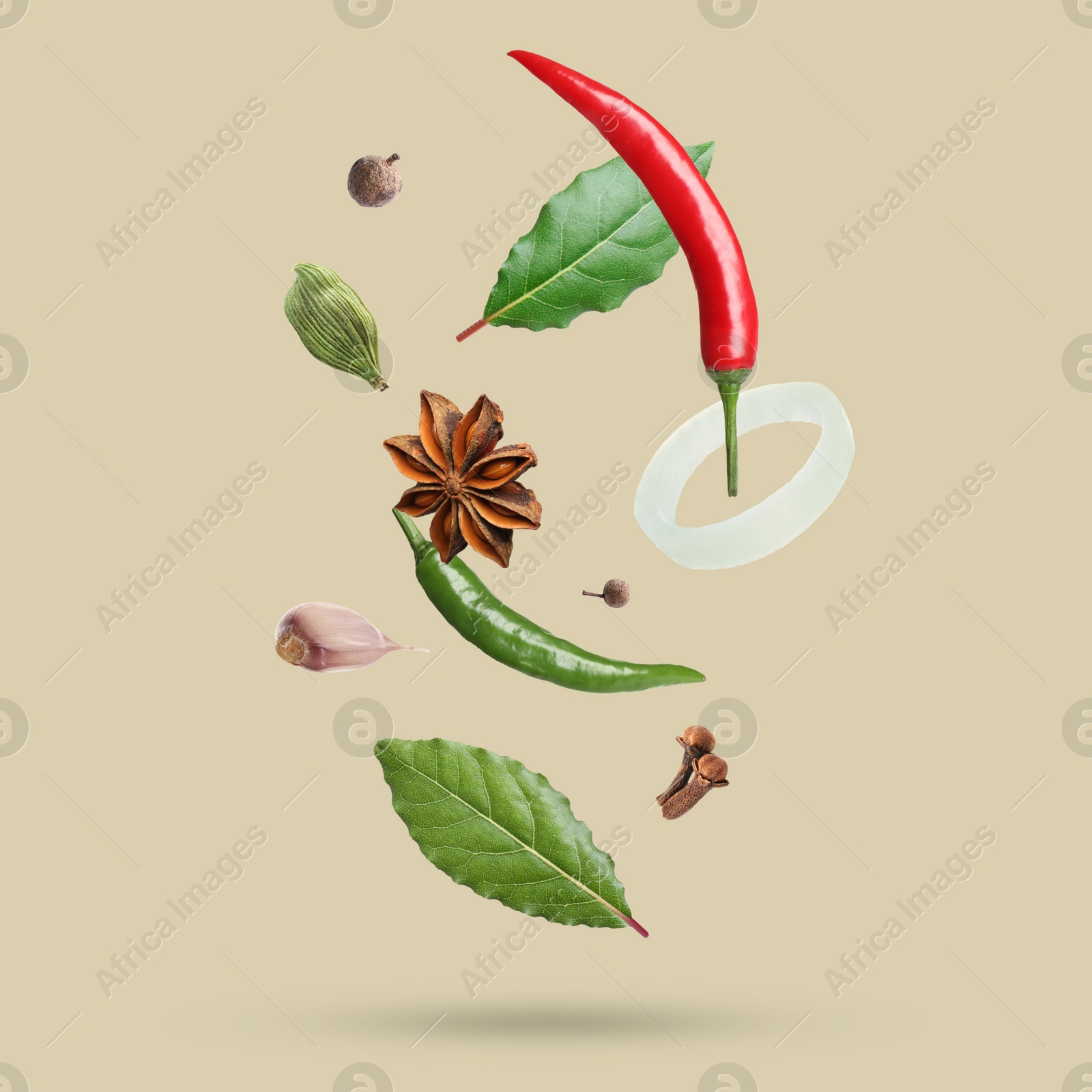 Image of Different spices falling on dark beige background