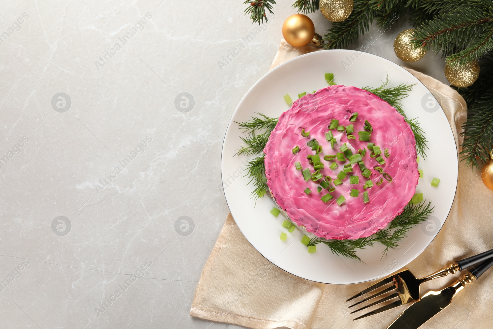 Photo of Herring under fur coat salad and Christmas decor on light grey table, flat lay with space for text. Traditional Russian dish