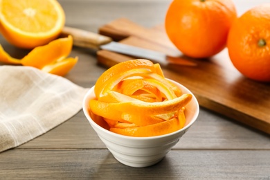 Fresh orange fruit peels on wooden table