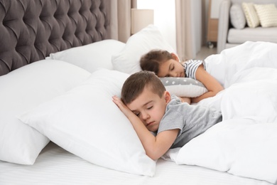Photo of Cute little children sleeping in comfort bed. Space for text