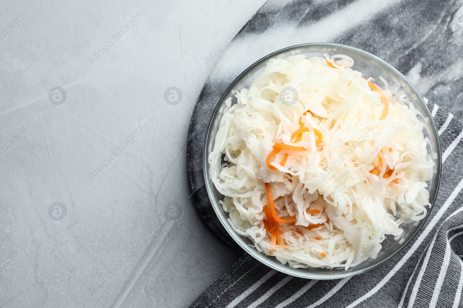 Photo of Tasty fermented cabbage on light grey table, top view