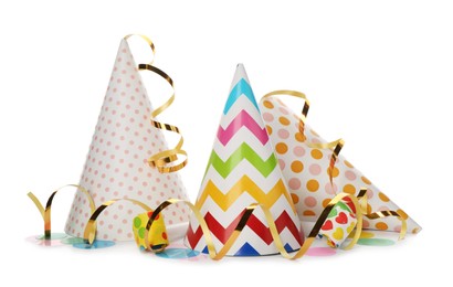 Party hats, blowers and confetti streamers on white background