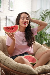 Photo of Beautiful young woman with watermelon at home