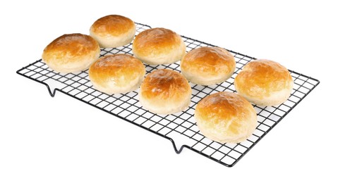Photo of Cooling rack with tasty scones prepared on soda water isolated on white