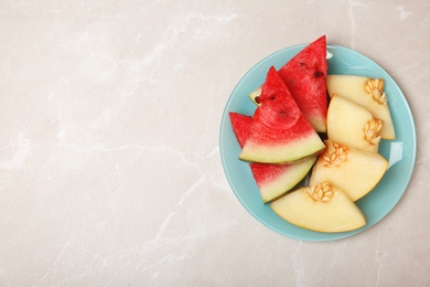 Photo of Cut tasty melon and watermelon on table. Space for text