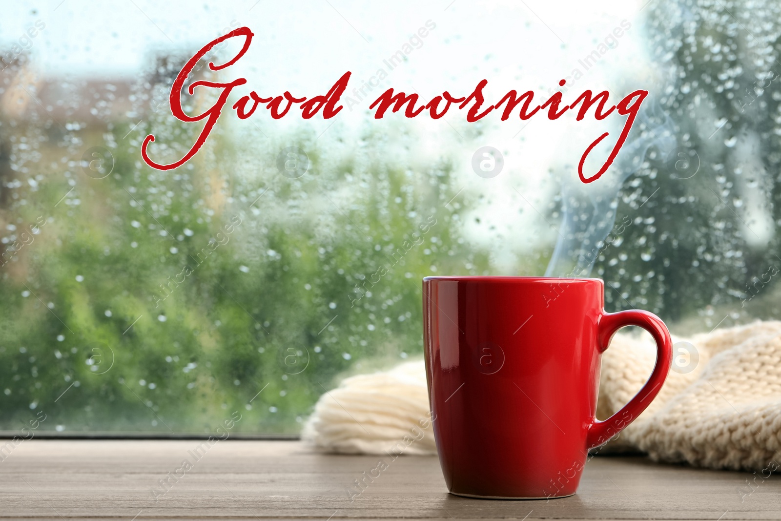 Image of Cup of hot drink and knitted plaid near window on rainy day. Good morning