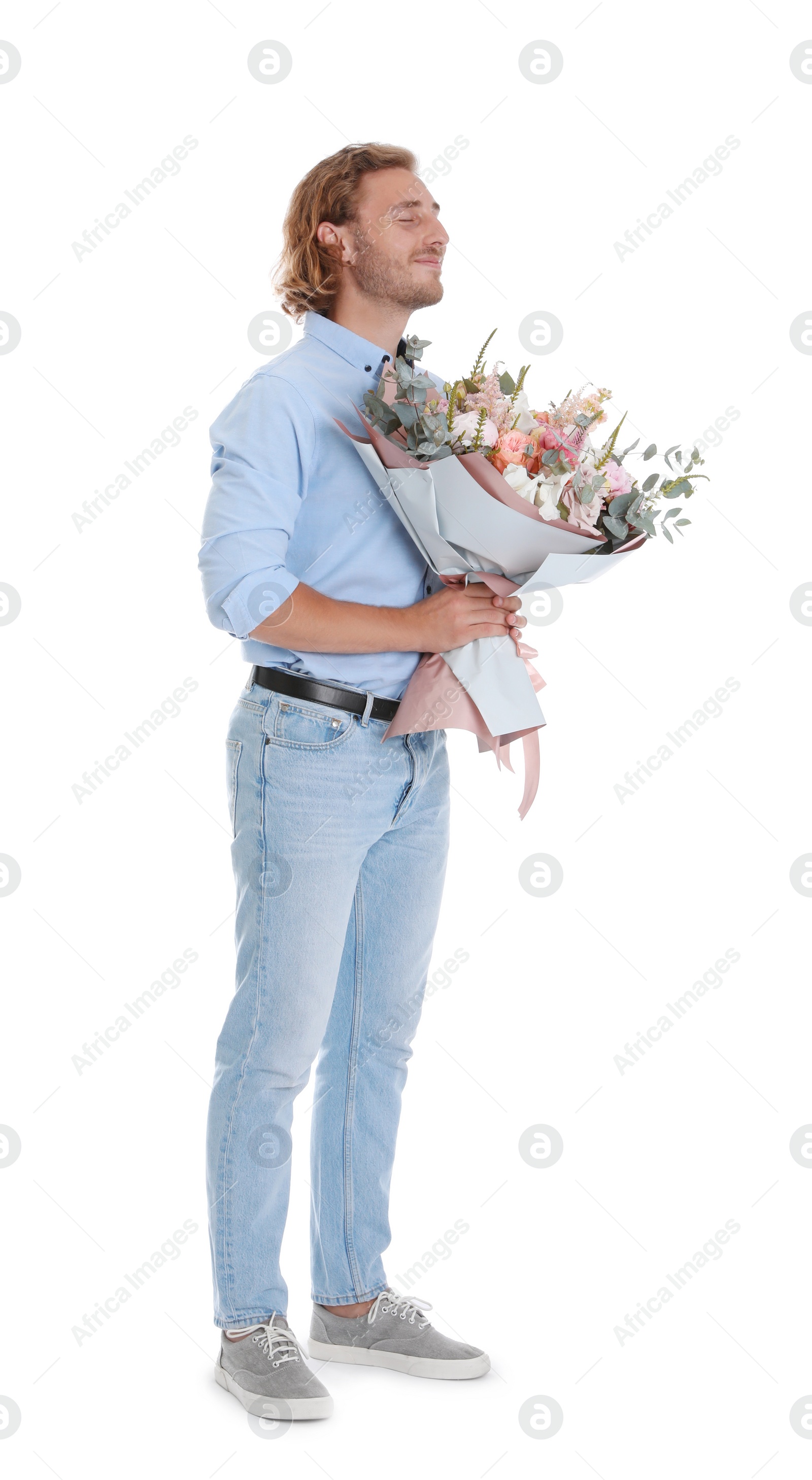 Photo of Young handsome man with beautiful flower bouquet on white background