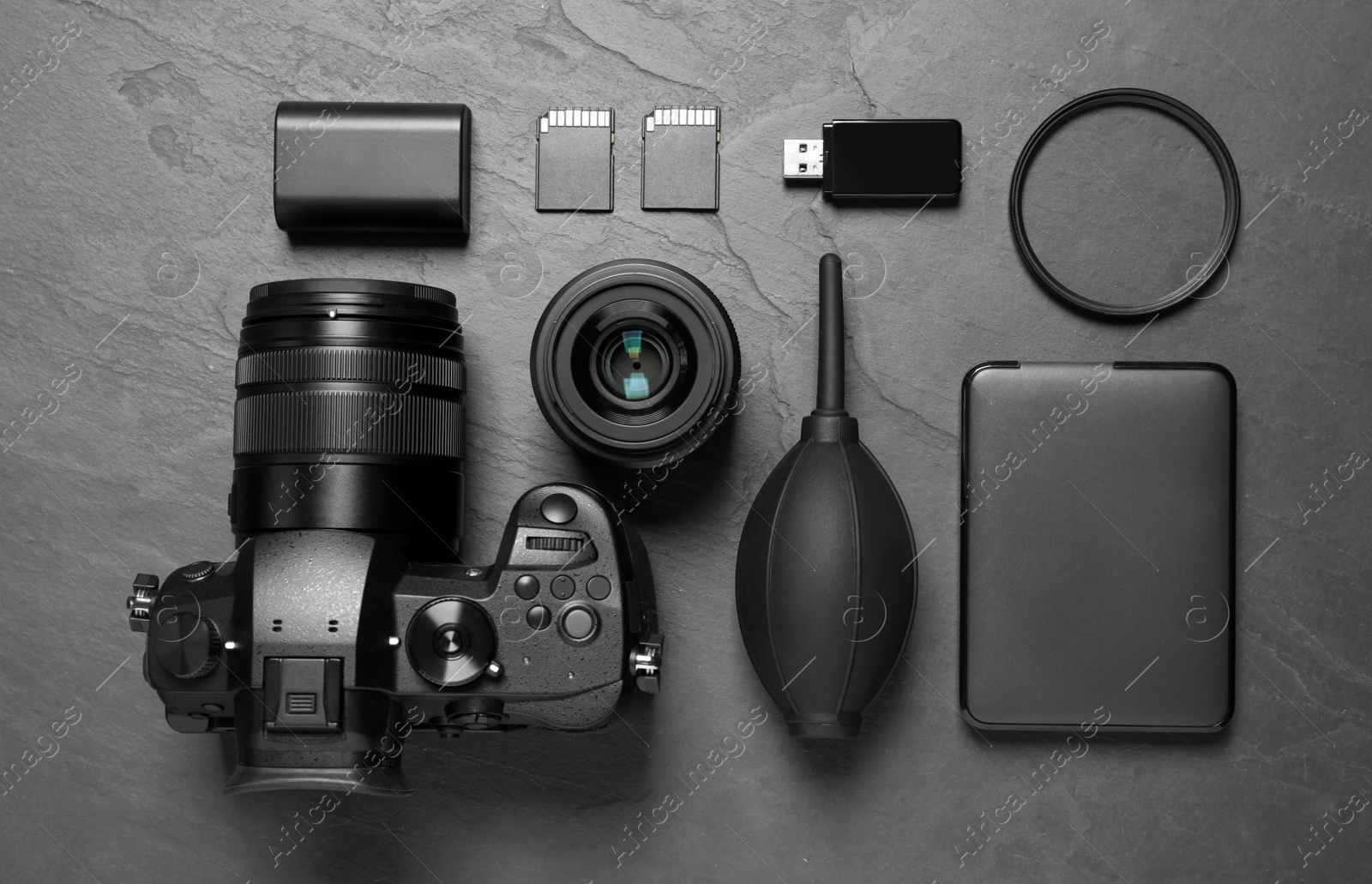 Photo of Flat lay composition with camera and video production equipment on grey stone background