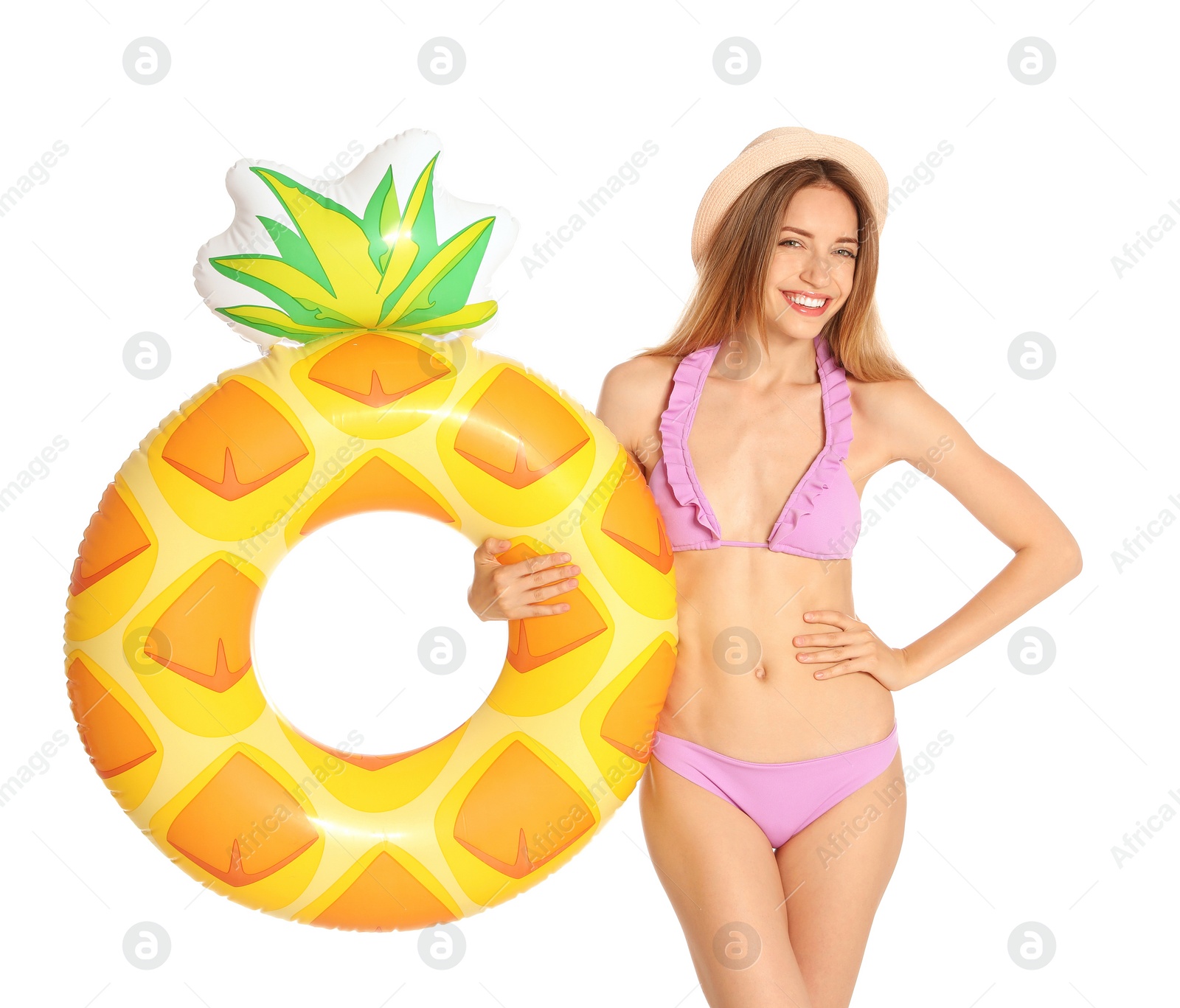Photo of Beautiful young woman in stylish bikini with pineapple inflatable ring on white background