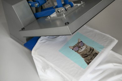 Image of Custom t-shirt. Using heat press to print photo of cute cat in sunglasses