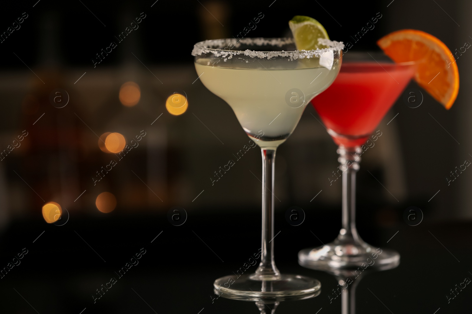 Photo of Different delicious cocktails on counter in bar