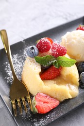Photo of Tasty vanilla fondant with white chocolate and berries on table, closeup