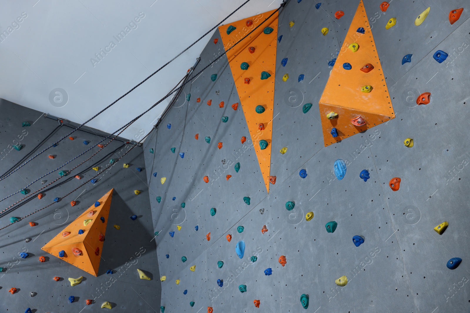 Photo of Climbing wall with holds in gym. Extreme sport