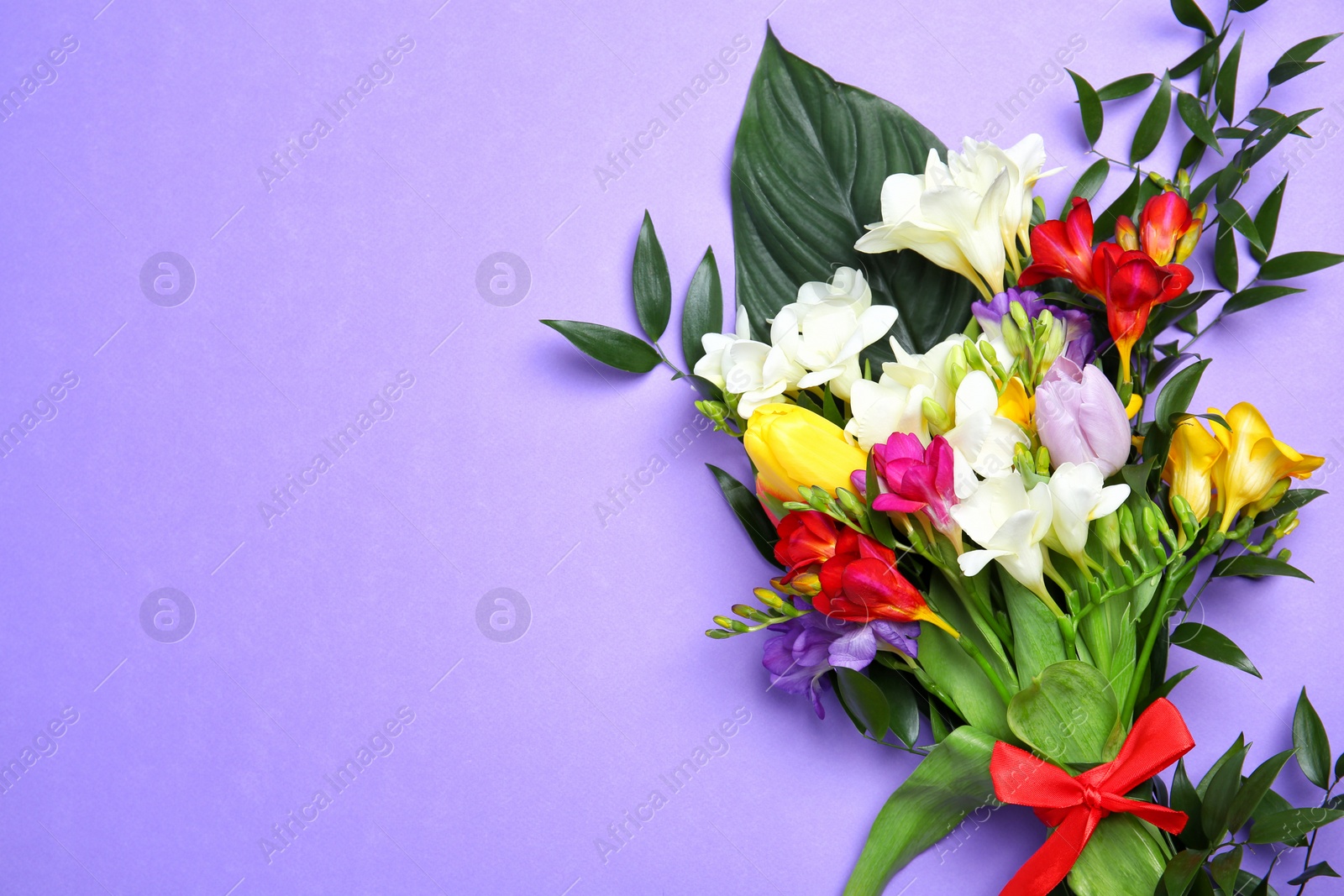 Photo of Beautiful freesia bouquet on color background