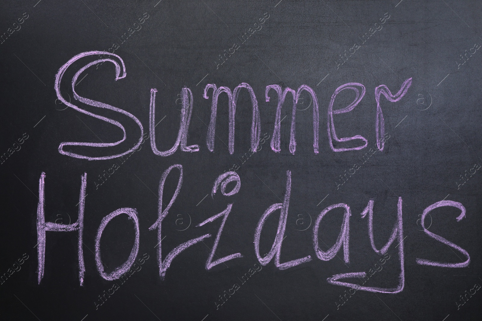 Photo of Phrase SUMMER HOLIDAYS written on black background. School's out