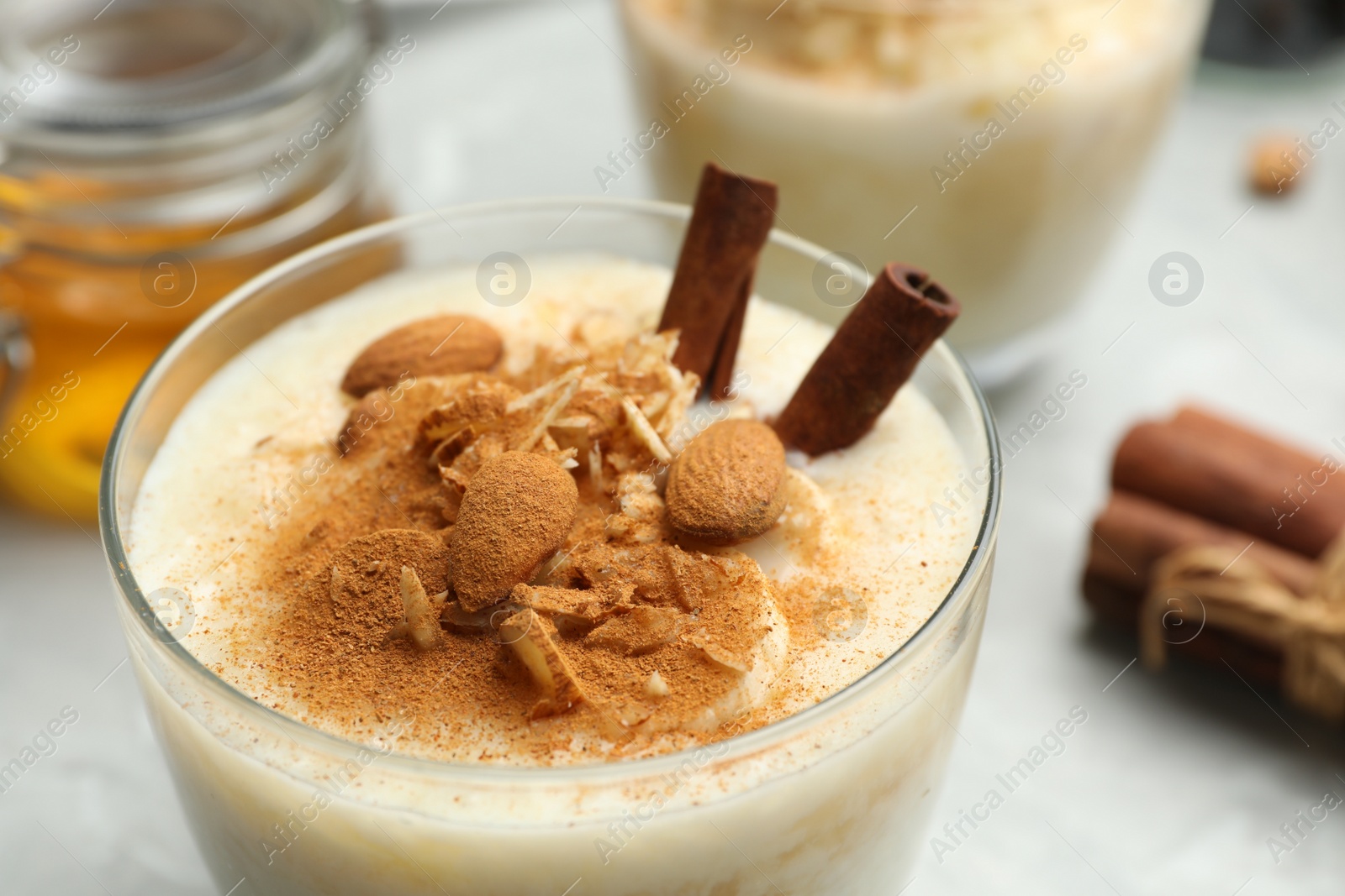 Photo of Delicious rice pudding with almonds and cinnamon, closeup