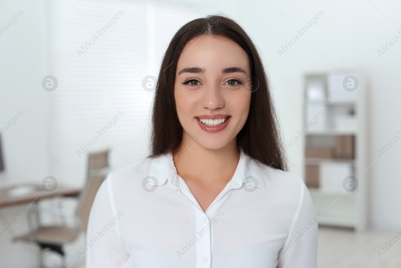 Photo of Portrait of beautiful young woman in office