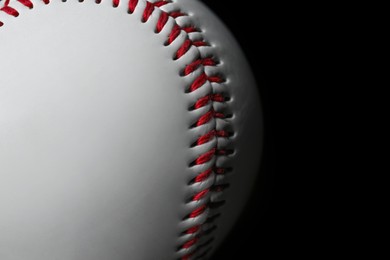 Photo of Closeup view of baseball ball on dark background, space for text. Sportive equipment
