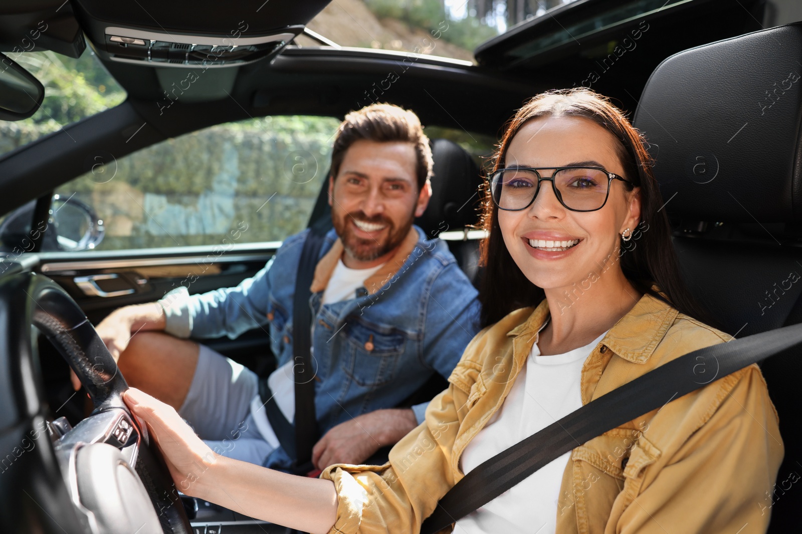 Photo of Happy couple enjoying trip together by car, selective focus