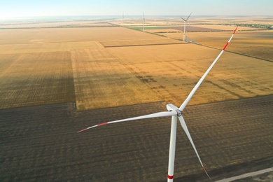 Modern windmill in wide field. Energy efficiency