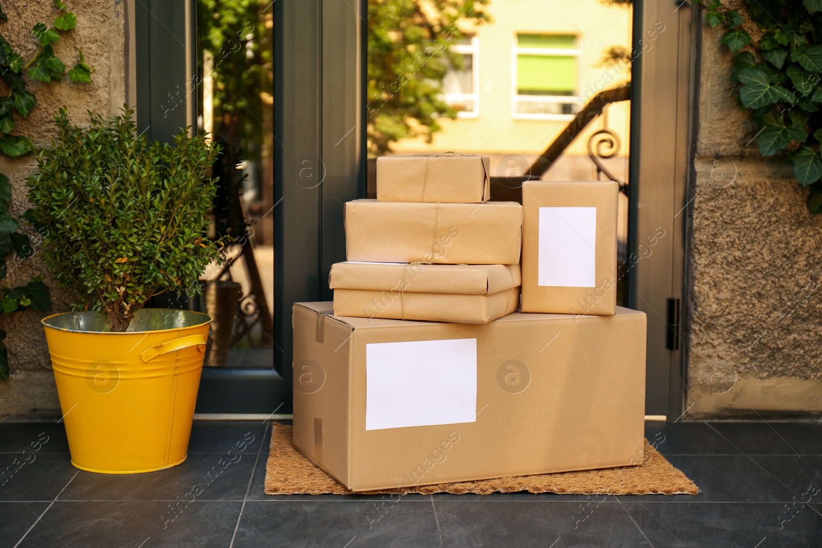 Photo of Delivered parcels on door mat near entrance