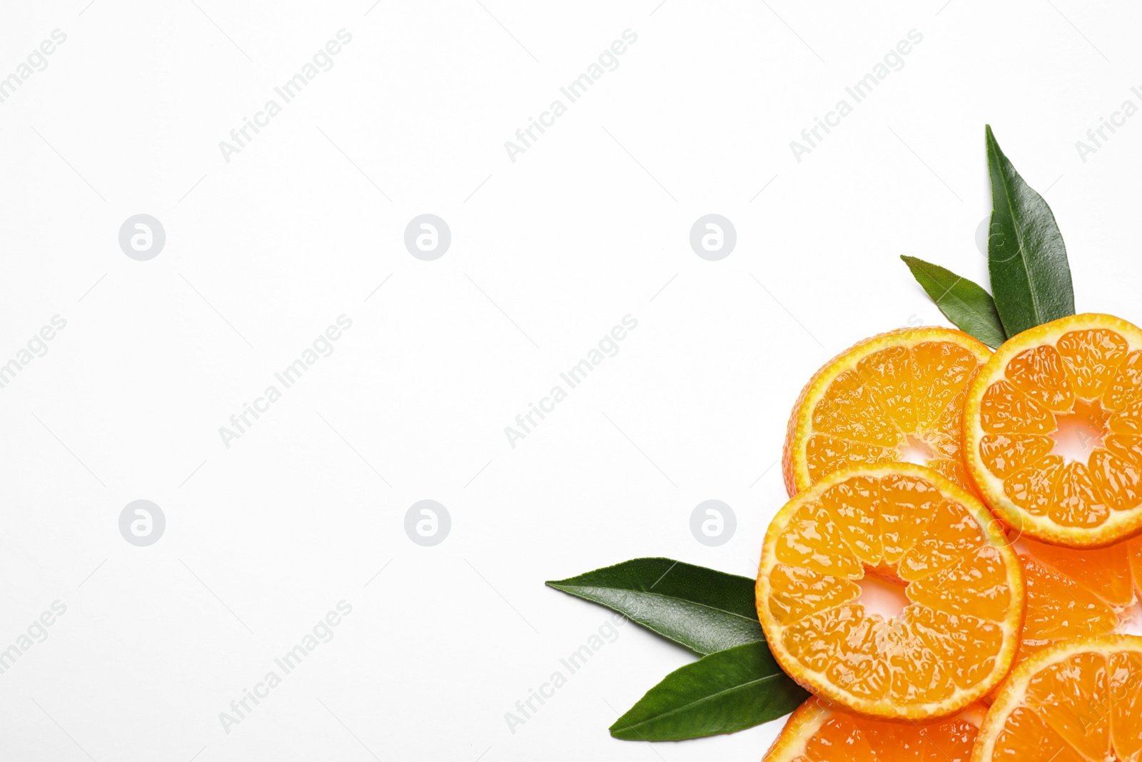 Photo of Composition with slices of fresh ripe tangerines and leaves on white background, top view. Citrus fruit