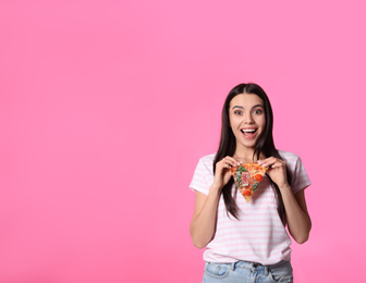 Emotional woman with pizza on pink background, space for text