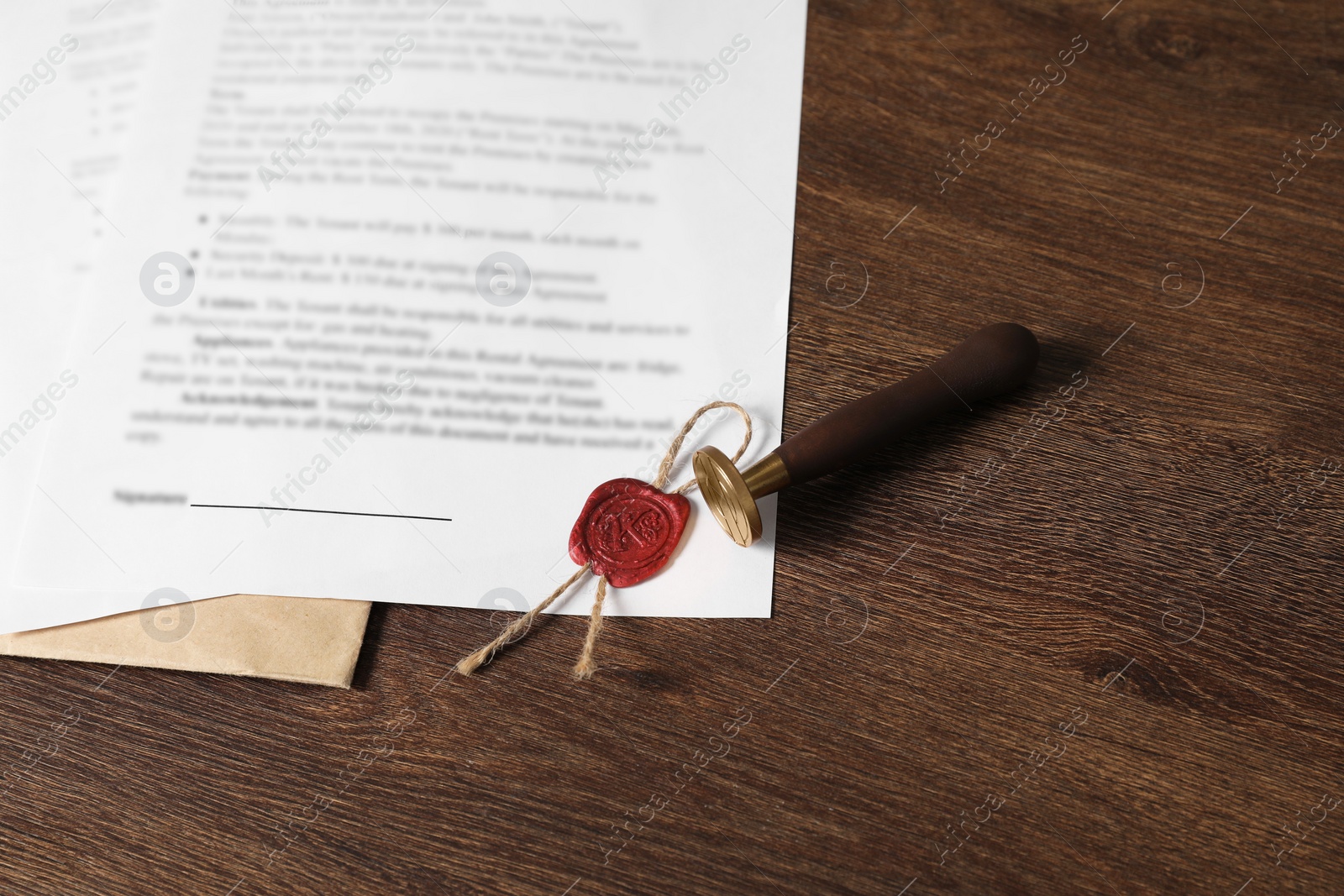 Photo of Documents and stamp on wooden table, above view. Notary contract