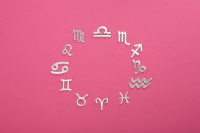 Photo of Zodiac signs on pink background, flat lay. Space for text