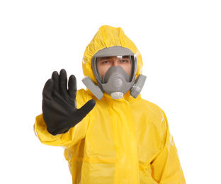 Man in chemical protective suit making stop gesture on white background. Virus research