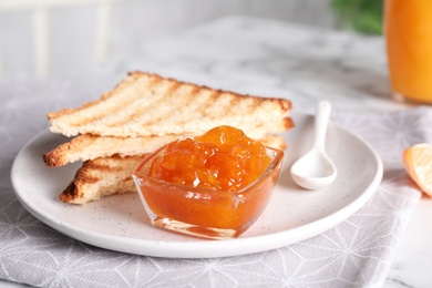 Photo of Tasty toasts and jam served for breakfast on table, closeup