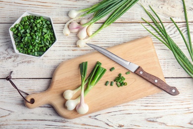 Photo of Beautiful composition with fresh green onion on table, top view