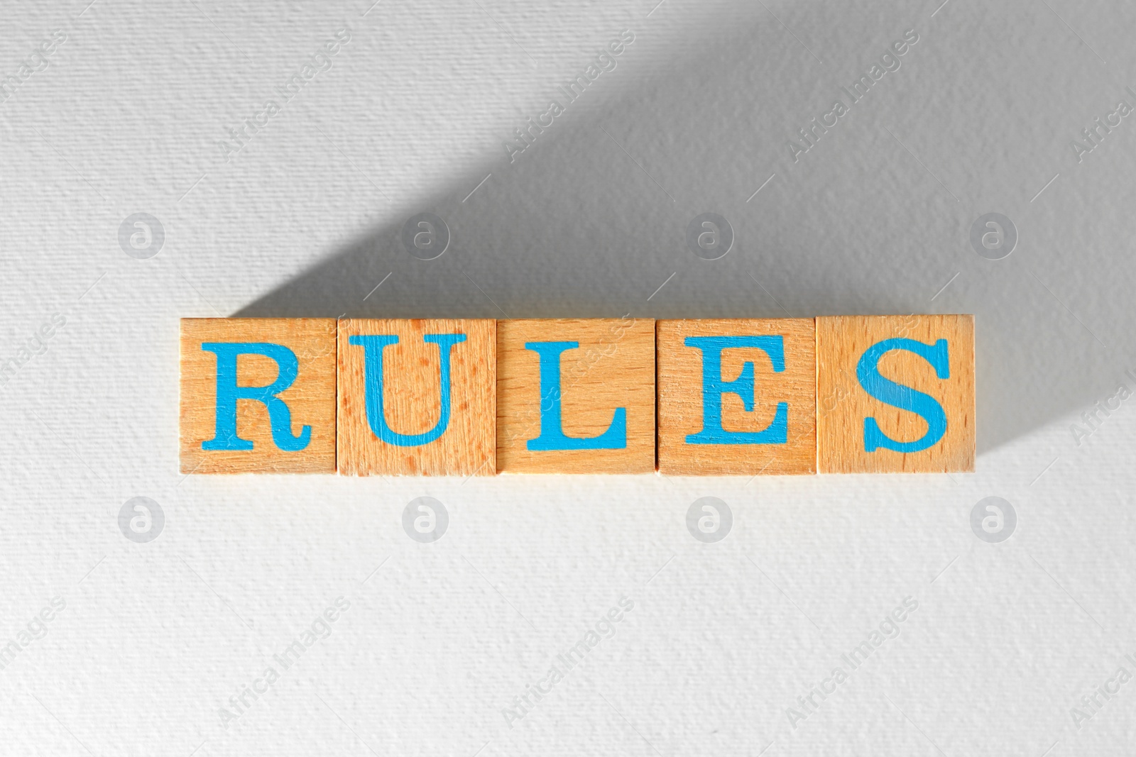 Photo of Word Rules made of wooden cubes with letters on white background, top view