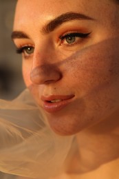 Photo of Fashionable portrait of beautiful woman with fake freckles, closeup