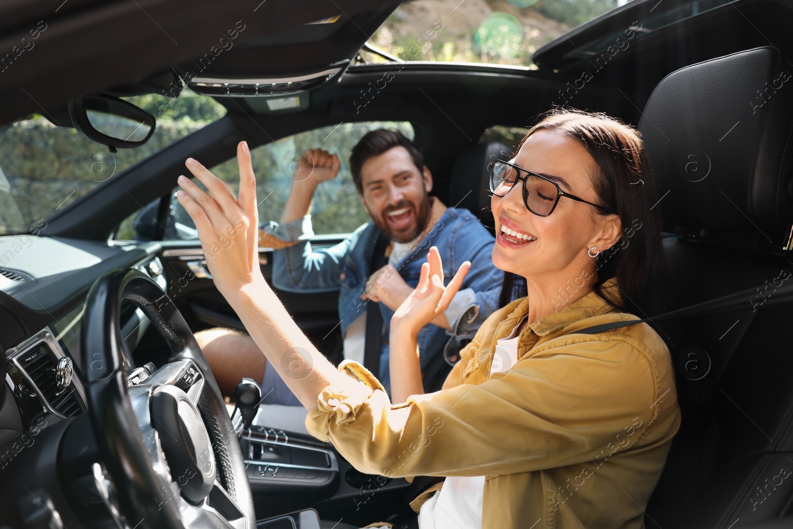 Photo of Happy couple enjoying trip together by car, selective focus