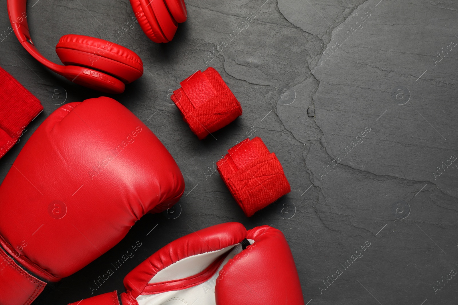 Photo of Different sports equipment on black table, flat lay. Space for text