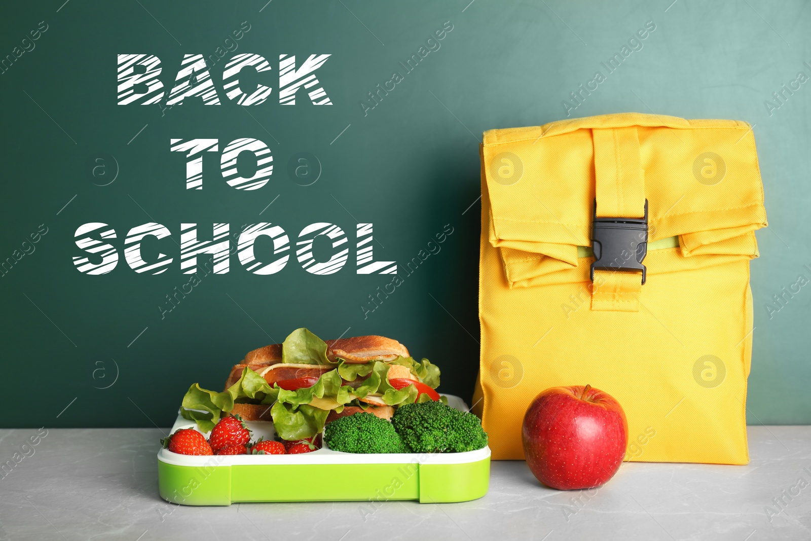 Image of Healthy food for school child on table near chalkboard