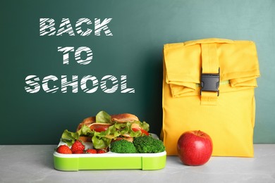 Image of Healthy food for school child on table near chalkboard