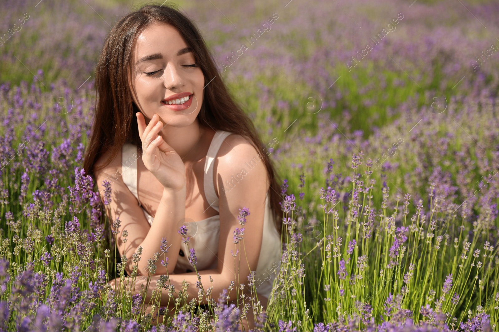 Photo of Young woman in lavender field on summer day