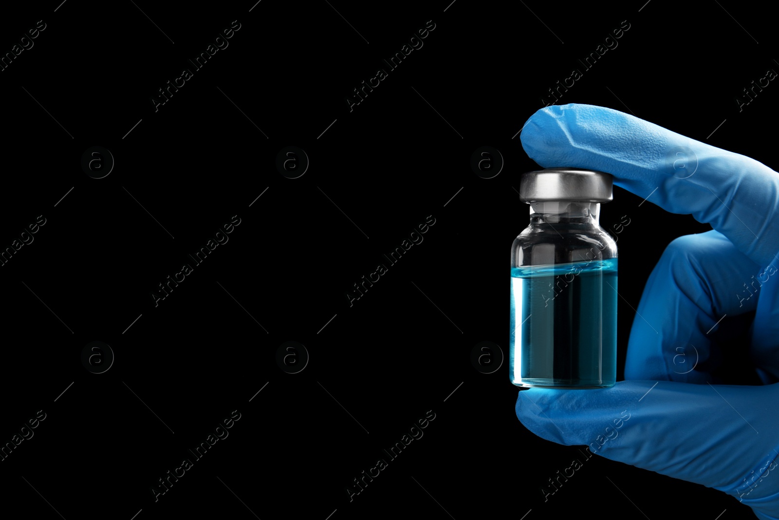 Photo of Doctor holding vial with medication on black background, closeup view and space for text. Vaccination and immunization