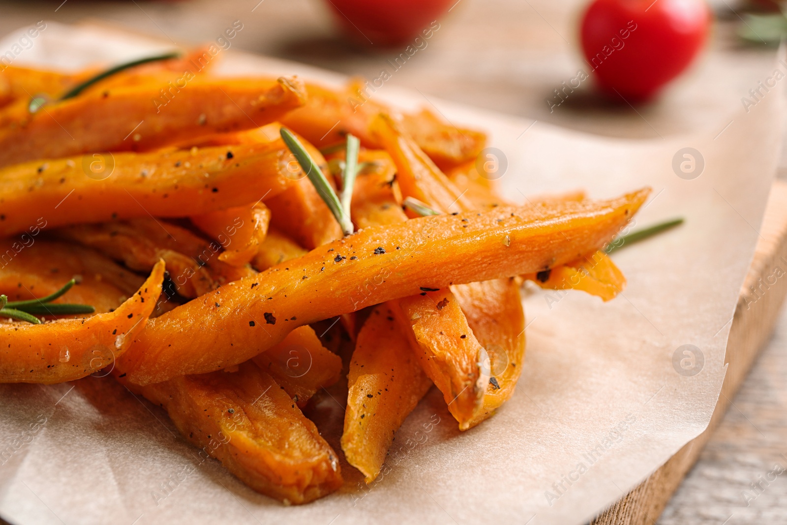 Photo of Sweet potato fries on wooden board, closeup