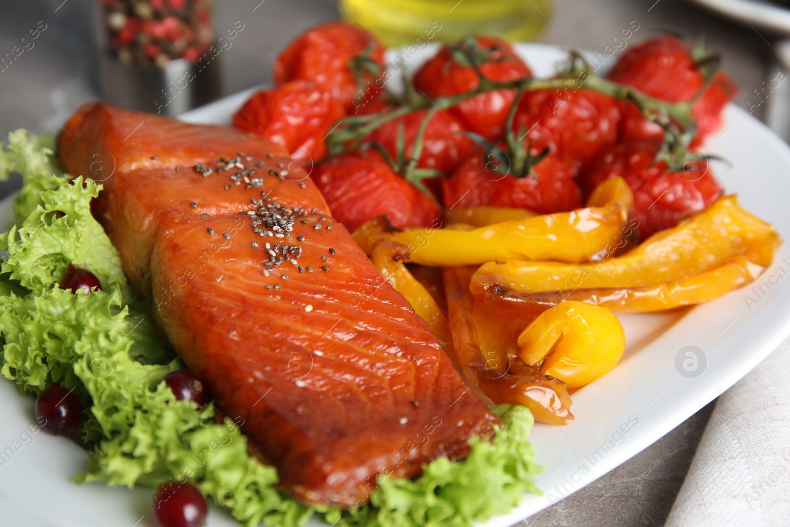 Photo of Tasty cooked salmon and vegetables served on grey table, closeup. Healthy meals from air fryer